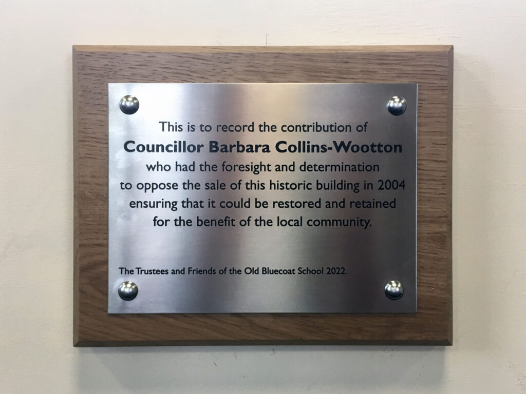 A plaque to Barbara Collins Wootton.